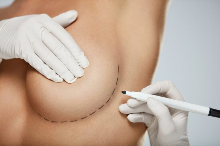 a photo of a woman having her breast examined by a doctor