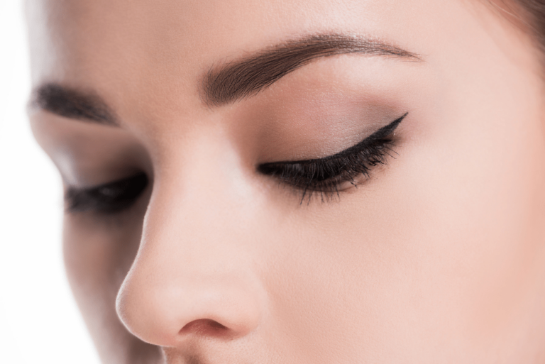 a close up photo of a woman's eyes and nose