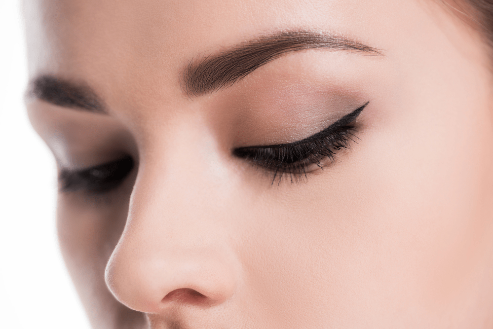 a close up photo of a woman's eyes and nose