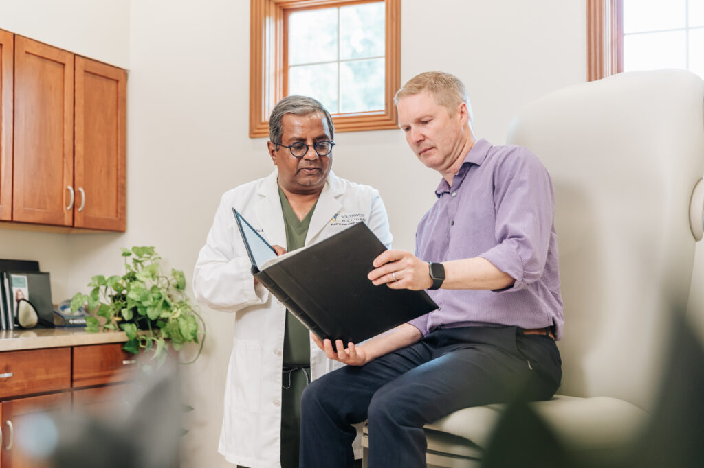 A doctor and a patient in a purple shirt complete a consultation for Skin Tightening in Portage