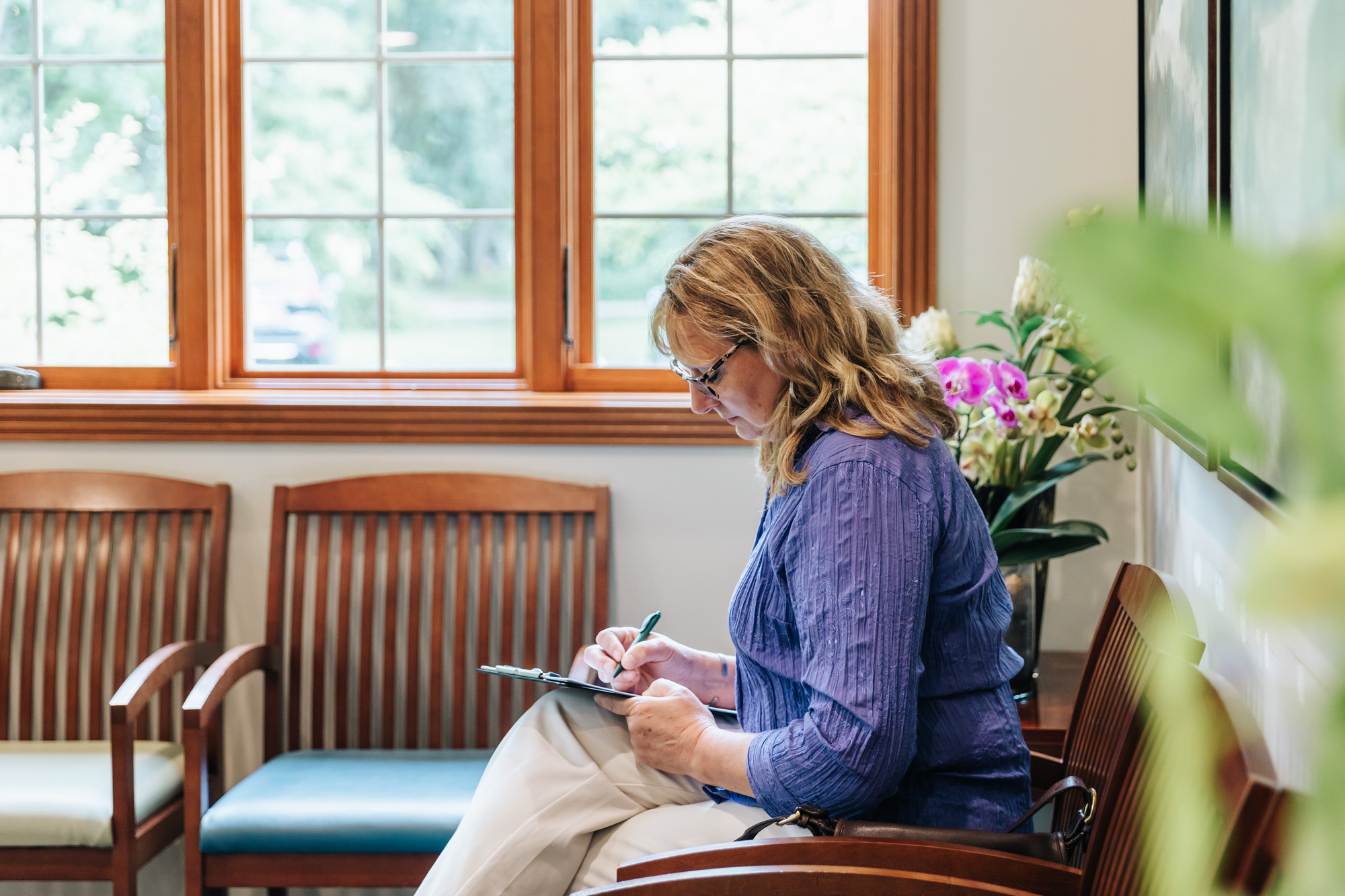 A woman signs in for Rosacea Treatment in Portage, MI