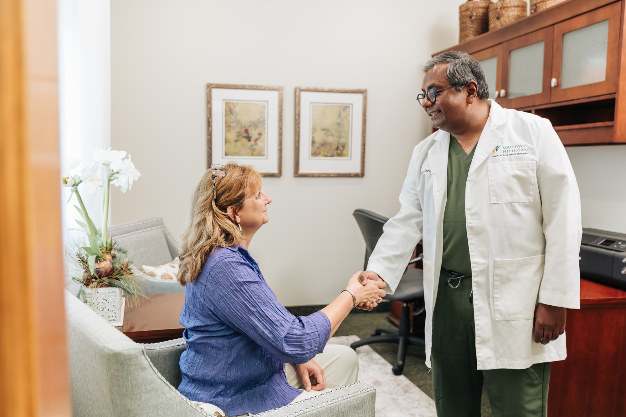 A woman in a purple blouse meets with a provider at our med spa near Kalamazoo.